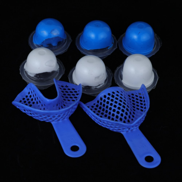 Blue dental impression trays with blue and white molding materials for custom grillz.