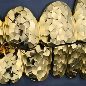 Gold-tone grillz with a faceted crushed ice finish.