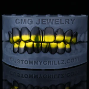 Black and yellow gradient upper and lower grillz on a dental model.