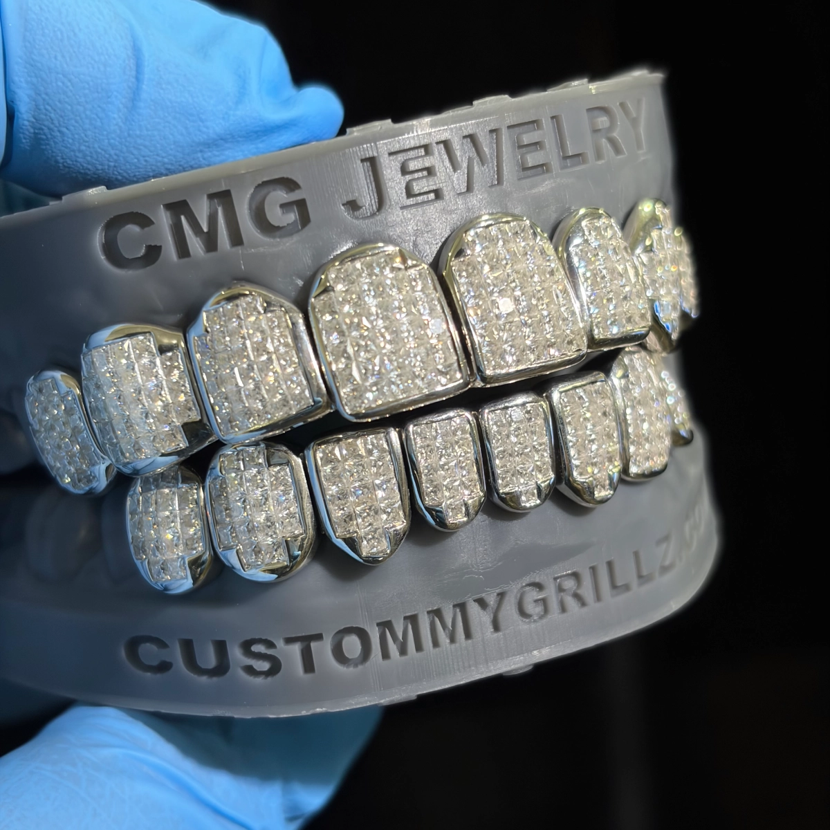 Grillz with closely arranged clear square-cut stones.