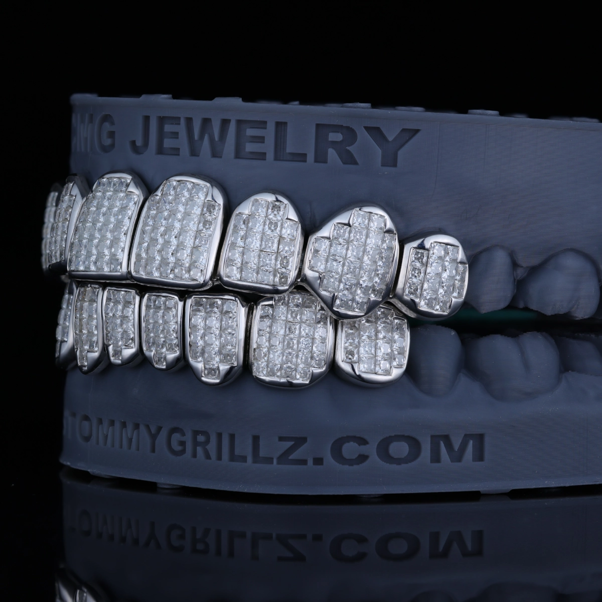 Grillz with closely arranged clear square-cut stones.