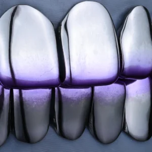Polished silver-tone upper and lower grillz with a purple gradient along the edges.