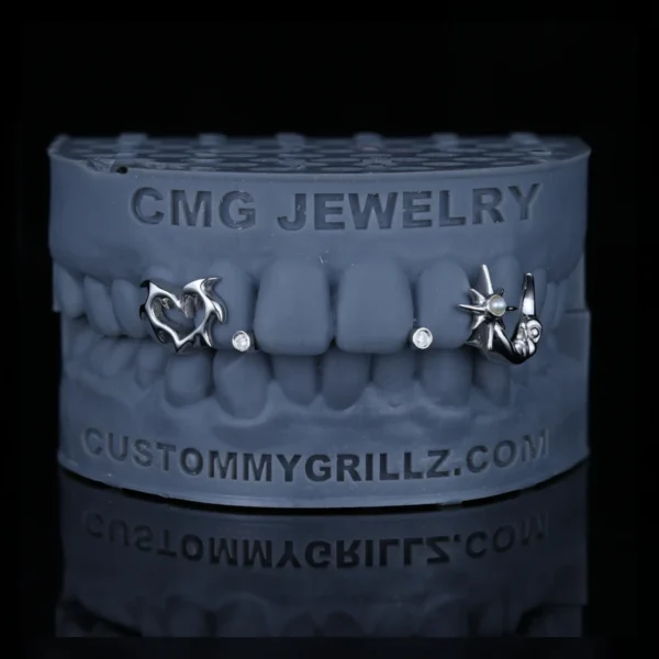 Gothic star moon and heart grillz with gemstone accents on a dental model